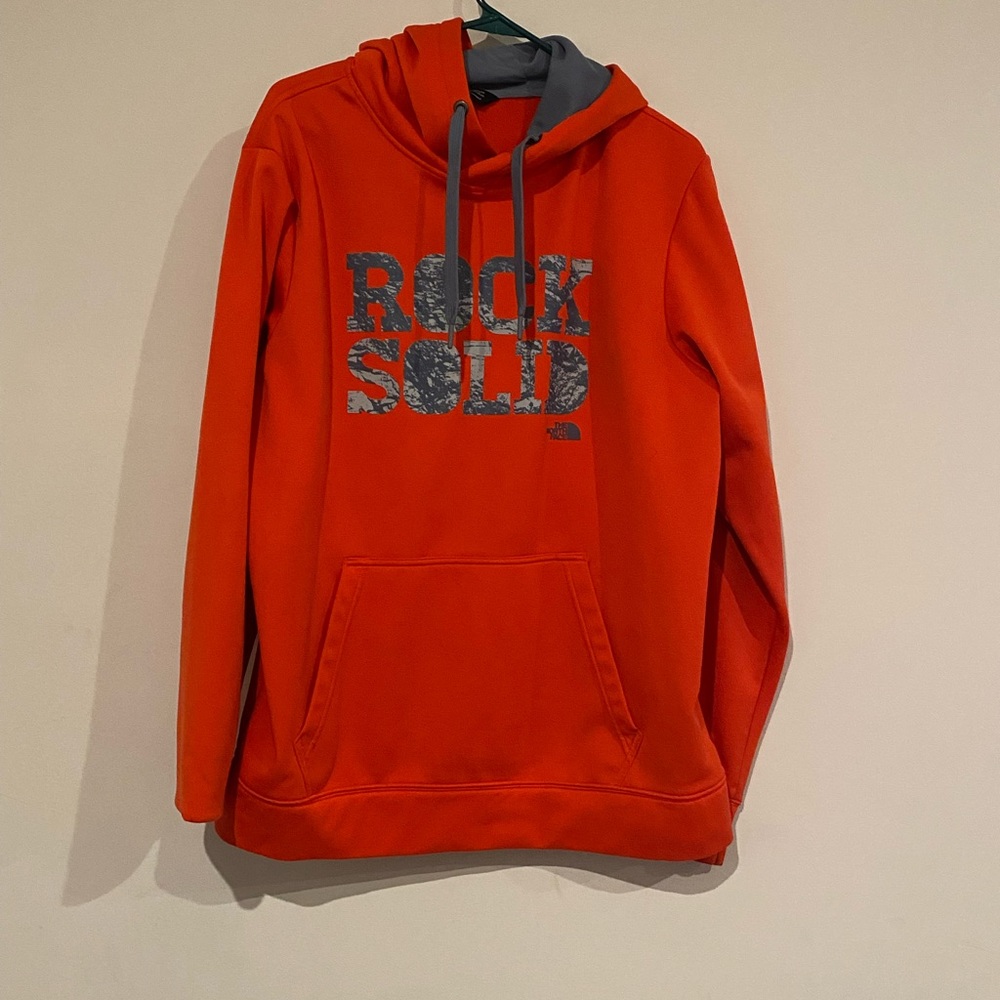 Orange The North Face hoodie.